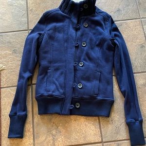 So Fleece jacket zips up and has button closure with pockets